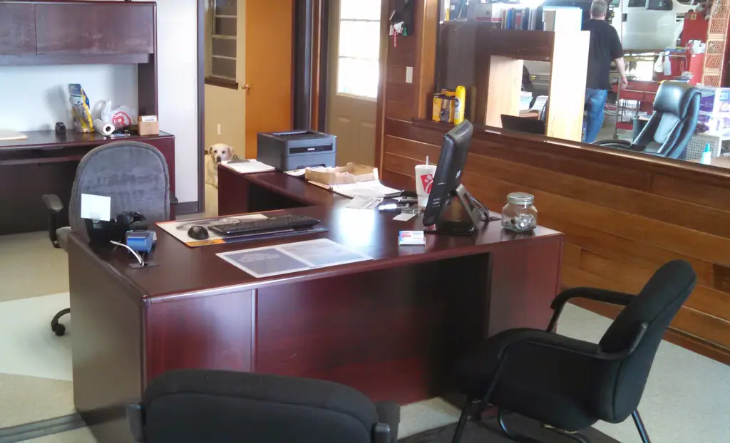 The front office at Michel Auto Cares, with the service counter and the shop floor visible through the interior window